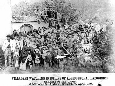 Crowd of men, women and children. Captioned: Villagers watching evictions of agricultural labourers.